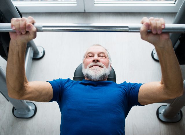 mature man doing barbell bench press, concept of body destroying fitness habits after 60