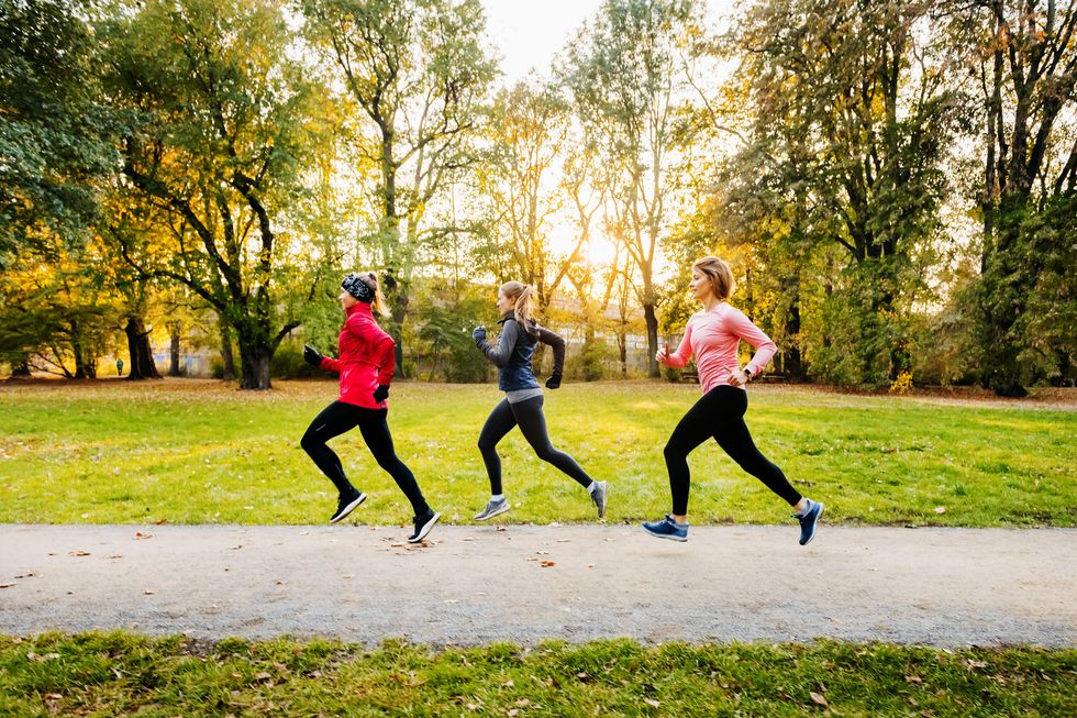 three women running in a non-urban area